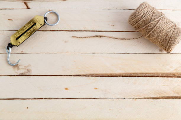 istock manual scales and a thread for wrapping on wooden background 1148795242