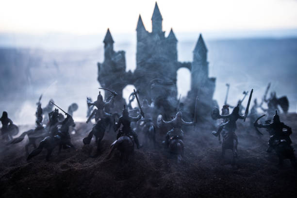 istock Medieval battle scene with cavalry and infantry. Silhouettes of figures as separate objects, fight between warriors on sunset foggy background. 1148795354