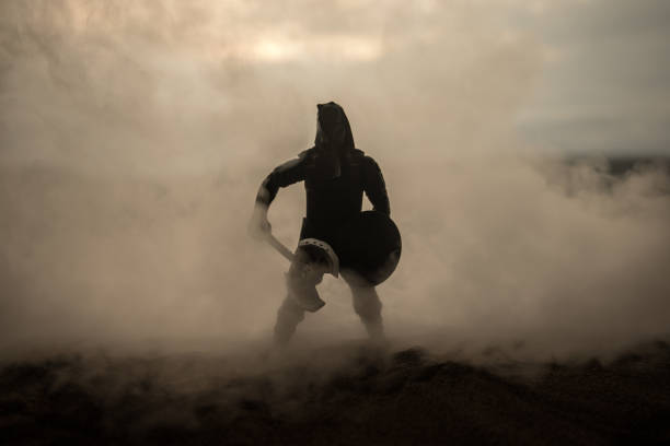 Medieval battle scene artwork decoration with toys. Silhouettes of figures as separate objects, fight between warriors on sunset foggy background. Selective focus