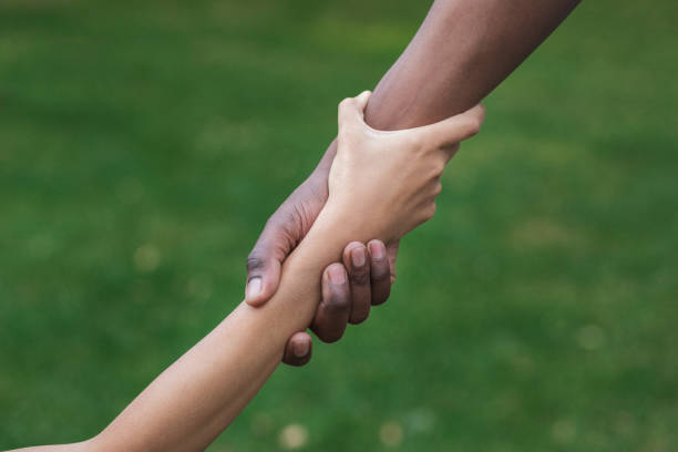 istock Multiethnic friends helping hand outdoor, copy space 1148796654