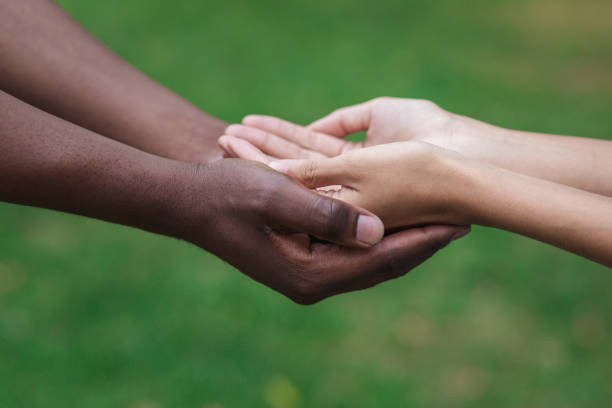 Diverse man and woman hands held together gesturing they need help, copy space