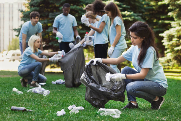 istock Young volunteers collecting garbage in suumer park 1148796672