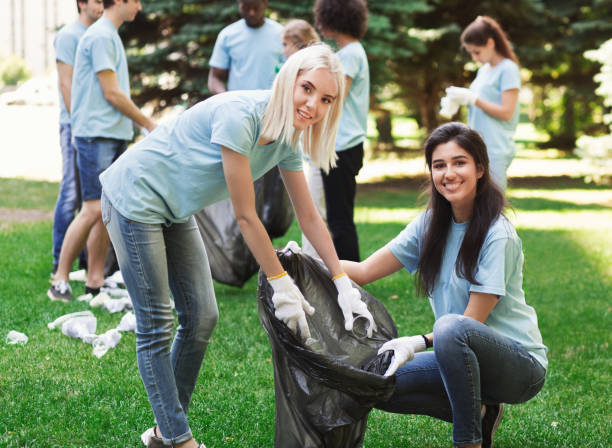 istock Volunteers collecting recyclable plastic bottles in park 1148796680