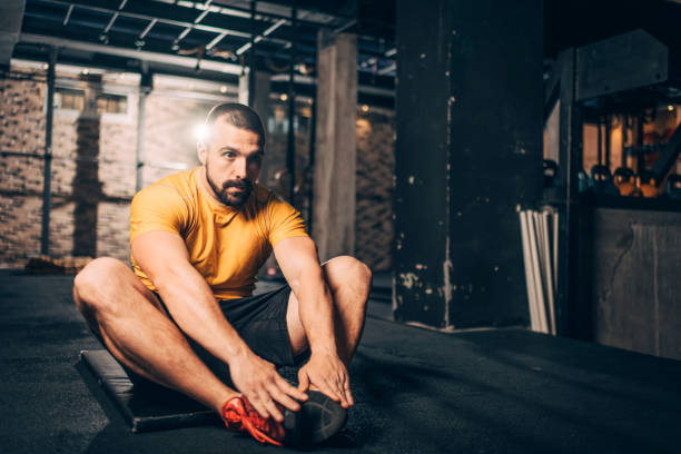 istock Active young athlete doing a butterfly sit ups exercise in a gym 1148796739