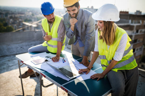 istock Team of architects and engineer in group on construciton site check documents and business workflow 1148798241