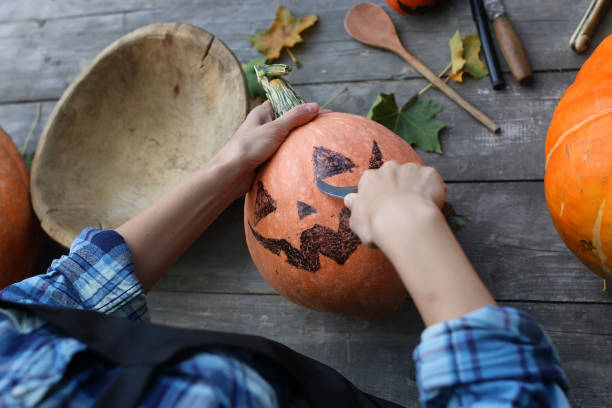 istock carve pumpkins for Halloween 1148798809