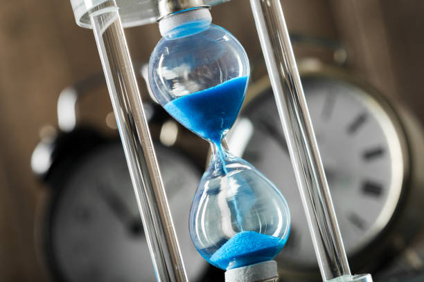 istock Time is passing. Blue hourglass close up 1148799143