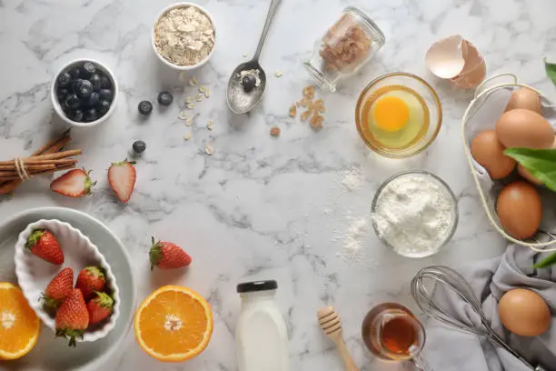 Ingredients for pancake,cake, baking on a marble background top view