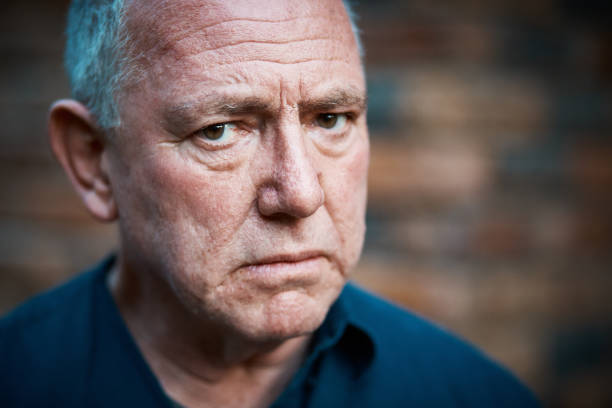 istock Senior man stares suspiciously at the camera 1148800818