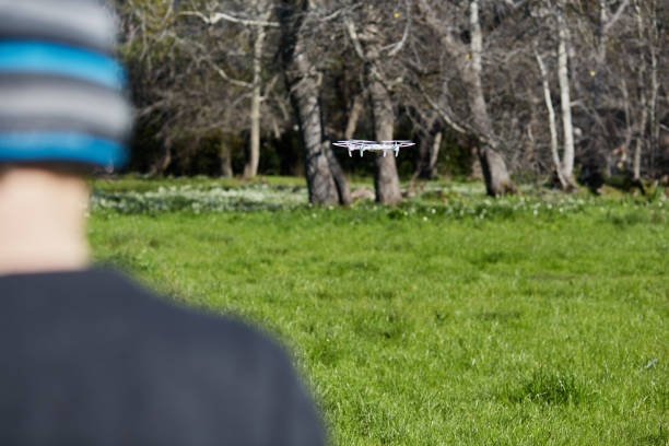 istock Rear view of adolescent boy flying a toy drone quadcopter 1148802441