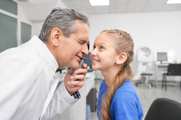istock Girl opening widely eyes while oculist checking eyesight 1148803889