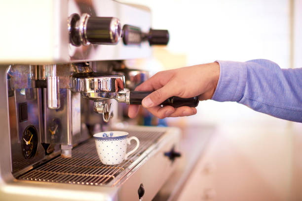 istock Clsoe-up shot of barista hands while brewing espresso coffee 1148805161