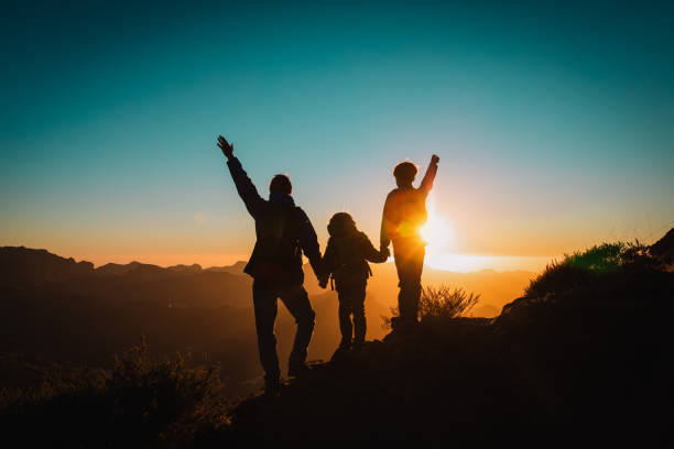 istock Happy father and kids hiking at sunset mountains 1148807779