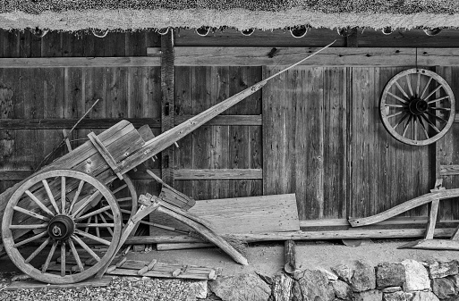old wooden wheelbarrow in farm house. Autumn harvest background