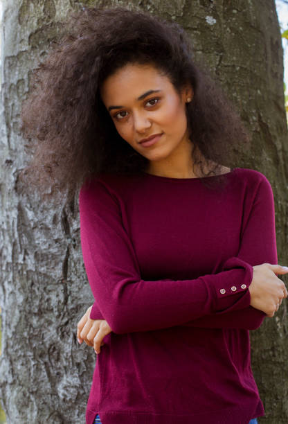 istock Young afro american woman looking at camera and smiling. 1148809006
