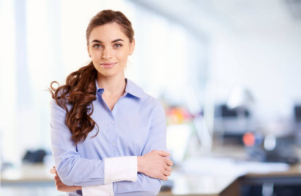 Portrait of smiling young businesswoman while standing in the office stock photo
