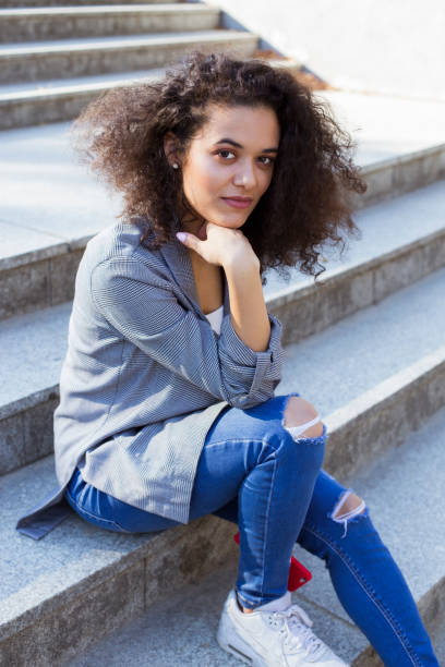 istock Young afro american woman looking at camera and smiling. 1148809093
