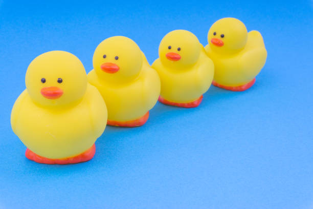 istock Yellow rubber duck on blue background. 1148809360