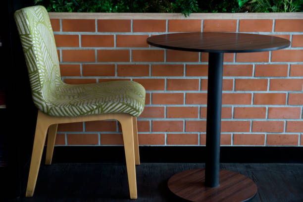 istock chair and table set in front of brick wall 1148812469