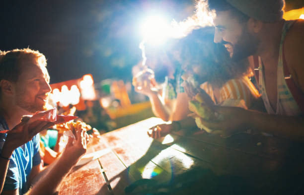 istock Friends having a bite at a concert. 1148813235