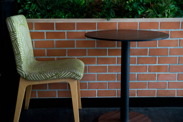 istock chair and table set in front of brick wall 1148813430