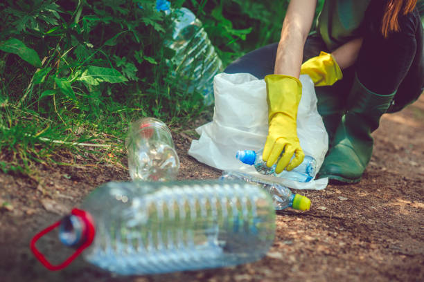 istock Volunteer collects garbage - plastic bottles in spring or summer outdoors 1148815468
