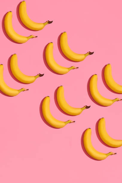 istock Pattern composition of a pair of bananas lying next to a pink background , top view 1148815938