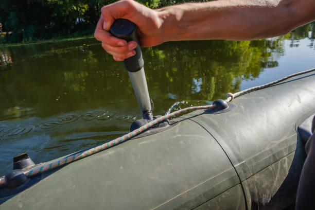 istock rubber boat, hunter fisherman man's hand holding paddle 1148818760