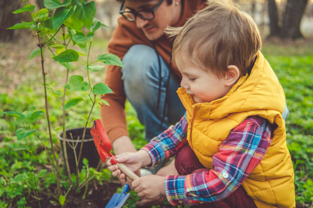 istock Family gardening outdoors on Arbor day in spring 1148819099
