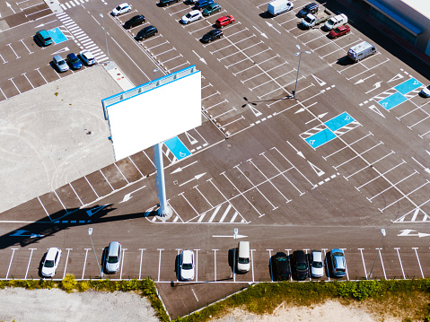 An aerial view of a large billboard in a parking lot