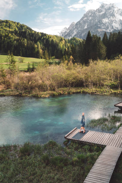 istock Woman practicing evening meditation yoga outdoors by the lake 1148820694