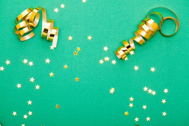 istock Golden decorations and sparkles on bright  green background 1148821762