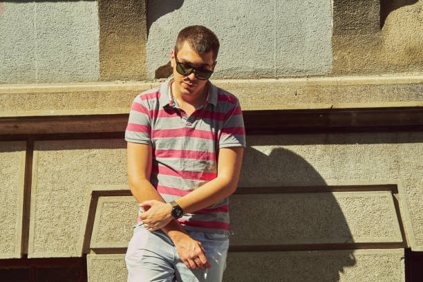 istock Young man smoking cigar on the street. 1148823560