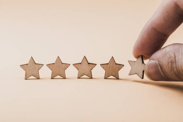 istock Hand putting wooden five star shape on table 1148823600