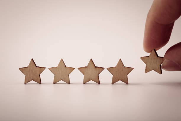 istock Hand putting wooden five star shape on table 1148823631