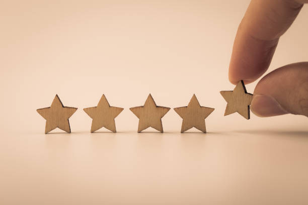 istock Hand putting wooden five star shape on table 1148823634