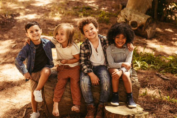 istock Group of kids on a wooden log 1148825441
