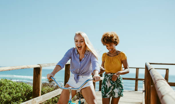 istock Cheerful friends having fun with a cycle 1148825662