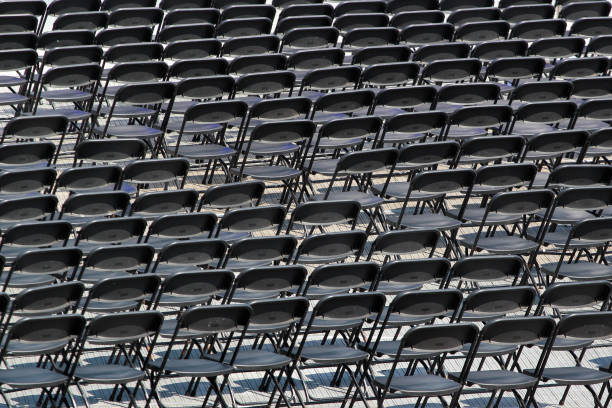 istock Multiple chairs outdoor, many black chair backs 1148825674
