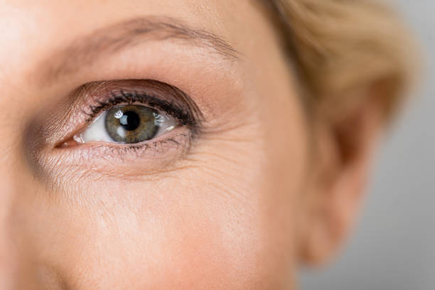 istock selective focus of mature woman looking at camera isolated on grey 1148826875