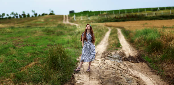 istock A woman walking on path in nature. 1148827723