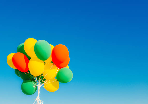 istock Colourful helium balloons against a blue sky 1148830977
