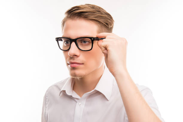 istock Attractive young man in white shirt touching his glasses 1148832471