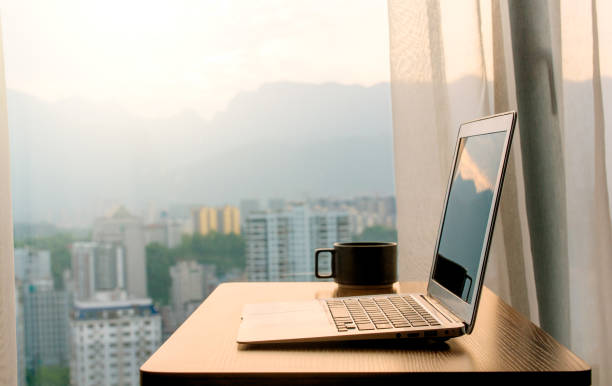 istock Laptop on a desk by window 1148832886