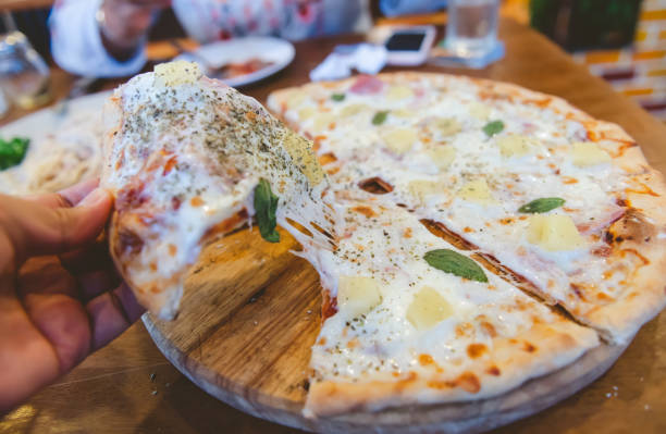 istock Stretch cheese piece of homemade pizza. 1148837147