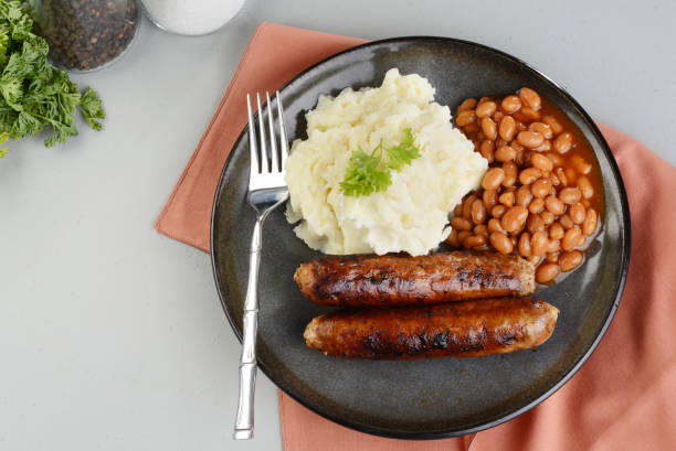 top view chorizo sausages with mashed potato and baked beans - sausage food mash grilled imagens e fotografias de stock