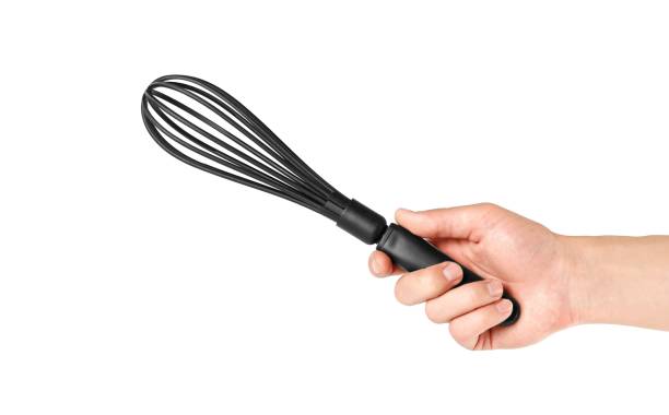 istock Hand holding a black plastic whisk. Close up. Isolated on white background 1148844393