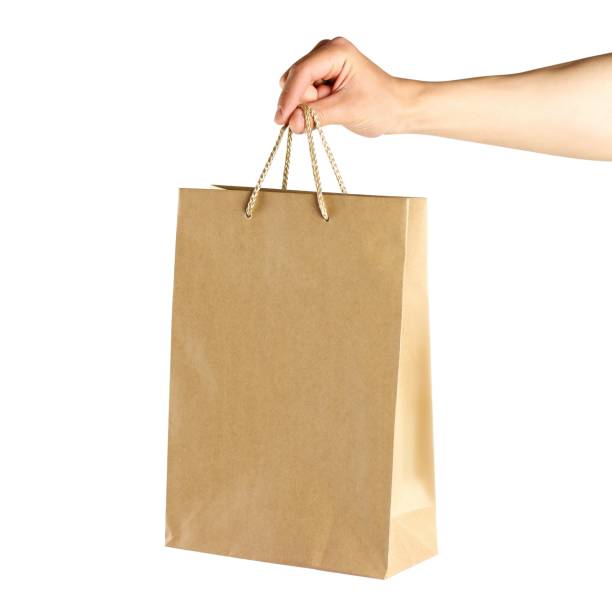 istock Hand holding a paper bag. Close up. Isolated on white background 1148844398