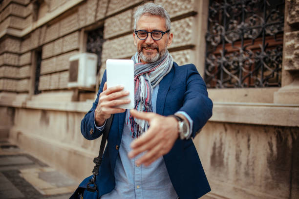 istock Fashionable Senior Man using reading glasses on digital tablet 1148844458