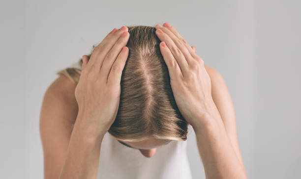 women's hair is a top view close-up. blonde woman is wearing shirt isolated on white. - full hair imagens e fotografias de stock